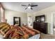 Comfortable bedroom with walk-in closet entry, closet, dresser and ceiling fan at 42519 W Centennial Ct, Maricopa, AZ 85138