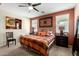 Stylish bedroom with a comfortable bed, modern ceiling fan and natural light at 42519 W Centennial Ct, Maricopa, AZ 85138