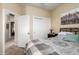 This bedroom features carpeted floors, a ceiling fan, and a double door closet at 42519 W Centennial Ct, Maricopa, AZ 85138