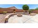 Inviting backyard fire pit with seating and a serene desert landscape at 42519 W Centennial Ct, Maricopa, AZ 85138