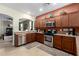 Well-equipped kitchen with stainless steel appliances and wooden cabinetry at 42519 W Centennial Ct, Maricopa, AZ 85138