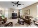 Comfortable living room featuring neutral tones, ceiling fan and stylish furnishings at 42519 W Centennial Ct, Maricopa, AZ 85138