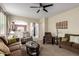 Spacious living room boasts a neutral color palette and seamlessly connects to other areas at 42519 W Centennial Ct, Maricopa, AZ 85138