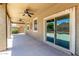 Spacious covered patio with ceiling fans and sliding glass door access to the home at 42519 W Centennial Ct, Maricopa, AZ 85138