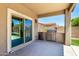 This patio features stainless steel grills, an enclosed space, and views of the backyard at 42519 W Centennial Ct, Maricopa, AZ 85138