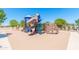 Community playground features multiple slides, climbing wall, and shaded areas for fun at 42519 W Centennial Ct, Maricopa, AZ 85138