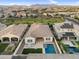 Aerial view of homes, green spaces, and community streets with mountain views in the distance at 4360 S Atom --, Mesa, AZ 85212