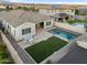 Aerial view of the backyard with a pool, patio, turf, and cozy seating area for relaxing or entertaining at 4360 S Atom --, Mesa, AZ 85212