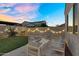 Backyard with patio furniture, artificial turf and block wall with string lights, perfect for outdoor entertaining at 4360 S Atom --, Mesa, AZ 85212