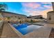 Enjoy the sparkling pool, string lights, landscaping, and exterior seating in this home's backyard at 4360 S Atom --, Mesa, AZ 85212