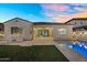 This home's pool and backyard features artifical grass, an outdoor seating area and exterior lights at 4360 S Atom --, Mesa, AZ 85212