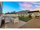 This backyard features artificial grass, landscape lighting and an outdoor seating area at 4360 S Atom --, Mesa, AZ 85212