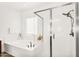 Bright bathroom features a luxurious soaking tub and separate glass-enclosed shower, complemented by a window for natural light at 4360 S Atom --, Mesa, AZ 85212