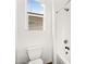 Bright bathroom featuring white toilet, shower, and window with natural light at 4360 S Atom --, Mesa, AZ 85212
