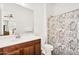 Bathroom with a single sink vanity, shower with a floral shower curtain, and toilet at 4360 S Atom --, Mesa, AZ 85212