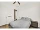 Bedroom with a ceiling fan, wood-look tile floor, open door and a closed door at 4360 S Atom --, Mesa, AZ 85212