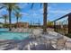 Community pool with lounge chairs and palm trees, perfect for relaxing and enjoying the outdoors at 4360 S Atom --, Mesa, AZ 85212