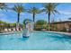 Resort-style community pool area with palm trees, lounge chairs, and a fun basketball hoop feature at 4360 S Atom --, Mesa, AZ 85212