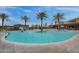 Large community pool surrounded by palm trees, lounge chairs, and resort-style amenities at 4360 S Atom --, Mesa, AZ 85212