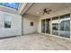 The covered patio includes a ceiling fan, travertine floor, and multiple entry points into the home at 4360 S Atom --, Mesa, AZ 85212