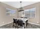A cozy dining room offers natural light and a modern chandelier above the dining table at 4360 S Atom --, Mesa, AZ 85212