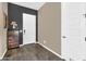 Inviting entryway with dark accent wall, wooden floors, and built-in storage at 4360 S Atom --, Mesa, AZ 85212