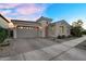 Charming home featuring a two-car garage, brick driveway, and inviting arched entryway at 4360 S Atom --, Mesa, AZ 85212