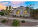 Attractive home boasting desert landscaping, a two-car garage, and a cozy exterior at 4360 S Atom --, Mesa, AZ 85212
