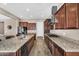 Beautiful kitchen with dark wood cabinets, granite countertops, and stainless steel appliances at 4360 S Atom --, Mesa, AZ 85212