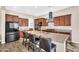 Modern kitchen with granite countertops, stainless steel appliances, and a center island with seating at 4360 S Atom --, Mesa, AZ 85212