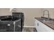 Modern laundry room features black washer and dryer with a sink and storage at 4360 S Atom --, Mesa, AZ 85212