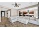Spacious living room with wood floors and a large sectional sofa leading into the kitchen area at 4360 S Atom --, Mesa, AZ 85212