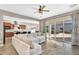 Bright living room featuring tile floors, a large sectional sofa, and sliding glass doors to the backyard at 4360 S Atom --, Mesa, AZ 85212