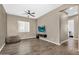 Spacious living room features tile flooring, ceiling fan, and large mounted TV at 4360 S Atom --, Mesa, AZ 85212