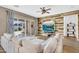 Comfortable living room with wood paneling, ceiling fan, and sliding doors to the backyard at 4360 S Atom --, Mesa, AZ 85212
