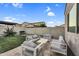 Backyard with an outdoor lounge area, grill, and block privacy wall with string lights at 4360 S Atom --, Mesa, AZ 85212