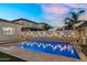 A tranquil pool with a lighted block wall, pavers and manicured landscaping creating a relaxing backyard retreat at 4360 S Atom --, Mesa, AZ 85212