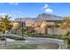 Neighborhood street view of well-maintained homes with desert landscaping and mountain views in the distance at 4360 S Atom --, Mesa, AZ 85212