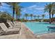 Resort-style swimming pool surrounded by palm trees and comfortable lounge chairs, perfect for relaxation and recreation at 4360 S Atom --, Mesa, AZ 85212