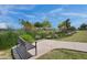 Community walking path with a bench, pond, and lush landscaping, perfect for relaxation and enjoying the outdoors at 4360 S Atom --, Mesa, AZ 85212