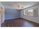 Bedroom featuring a ceiling fan, wood floors, and ample natural light from the window at 4515 N 35Th St, Phoenix, AZ 85018