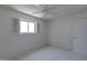 This bedroom features a ceiling fan, window, and neutral walls and carpet at 4515 N 35Th St, Phoenix, AZ 85018