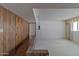 Split-level living room with wood paneling, brick accent, and vintage hanging light fixture at 4515 N 35Th St, Phoenix, AZ 85018