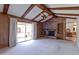 Inviting living room with exposed ceiling beams, a brick fireplace, and sliding glass doors to the backyard at 4515 N 35Th St, Phoenix, AZ 85018