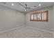 Bright bedroom features a modern ceiling fan and a window with wooden shutters at 4602 W Monte Cristo Ave, Glendale, AZ 85306