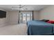 Bedroom with carpeted floors, access to the backyard through french doors, and ceiling fan at 4602 W Monte Cristo Ave, Glendale, AZ 85306
