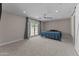 Bedroom with carpeted floors, backyard access through french doors, and a ceiling fan at 4602 W Monte Cristo Ave, Glendale, AZ 85306