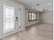 Entryway featuring decorative glass front doors, natural light, and wood-style tile flooring at 4602 W Monte Cristo Ave, Glendale, AZ 85306