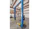 Close-up of a sturdy auto lift in a garage setting, designed for efficient vehicle maintenance and repair tasks at 4602 W Monte Cristo Ave, Glendale, AZ 85306