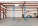 Well-lit garage interior equipped with an auto lift, offering a practical workspace for vehicle maintenance and repairs at 4602 W Monte Cristo Ave, Glendale, AZ 85306